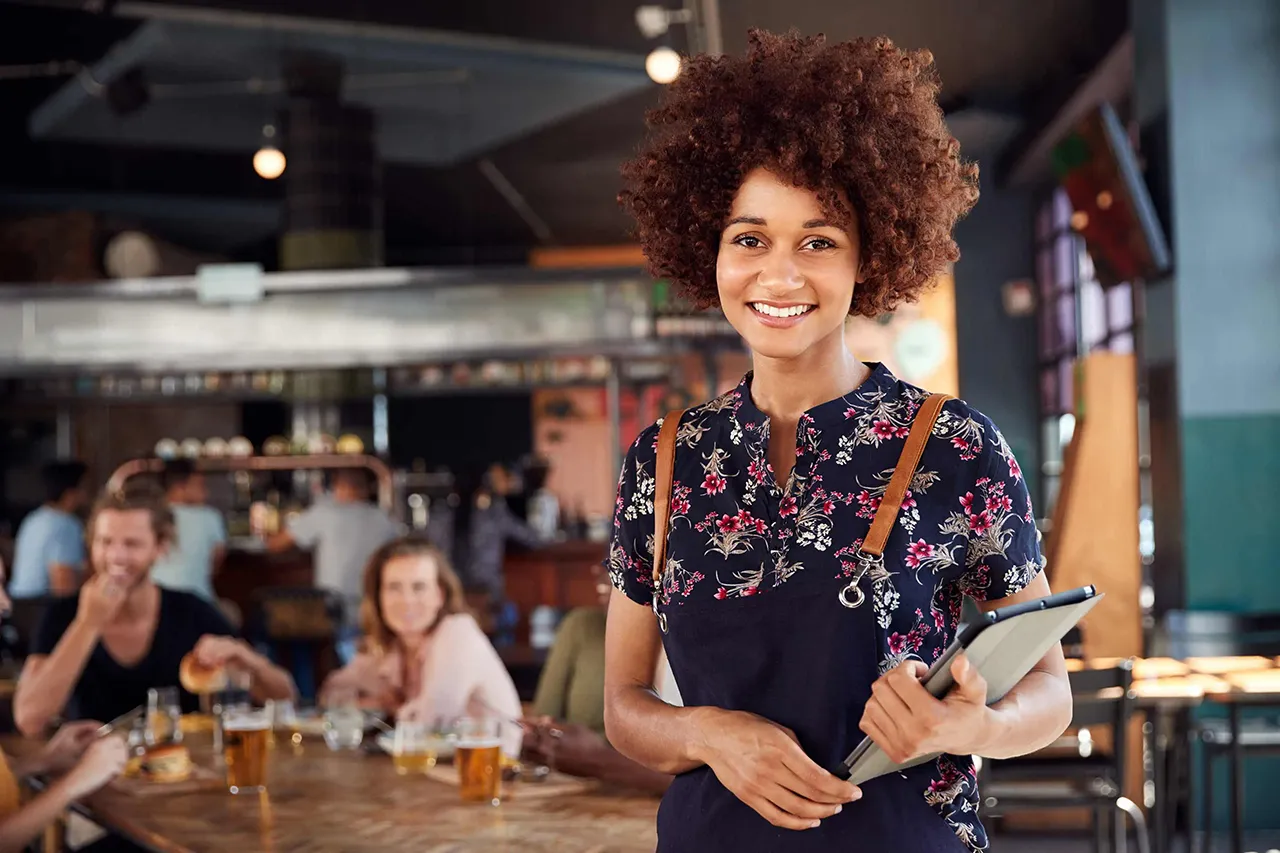 Female African American waitress standing in restaurant