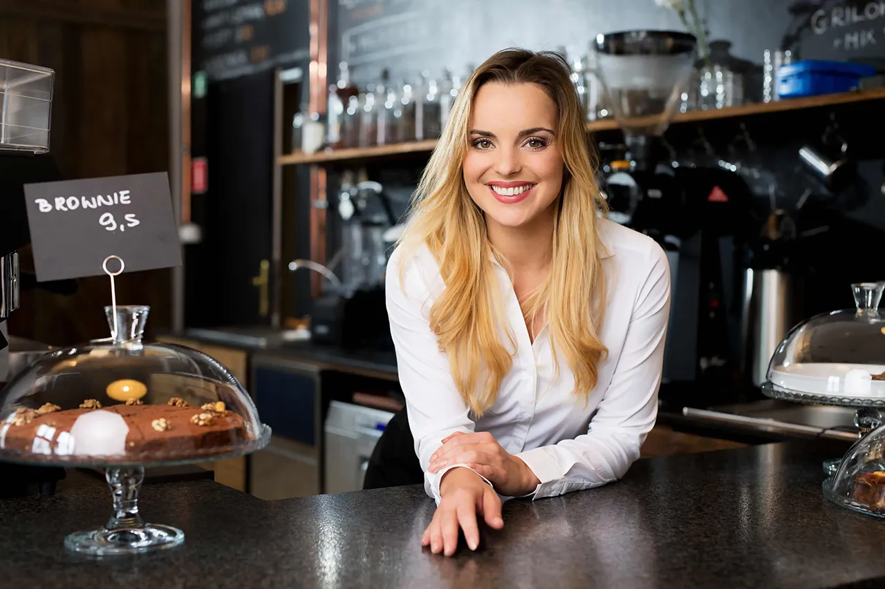 Female barista standing behind counter